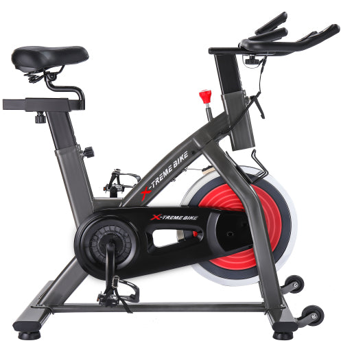 Teal Simba indoor cycling bike with 4-way adjustable handlebar and seat, LCD monitor for tracking workout stats.
