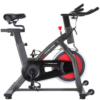 Teal Simba indoor cycling bike with 4-way adjustable handlebar and seat, LCD monitor for tracking workout stats.