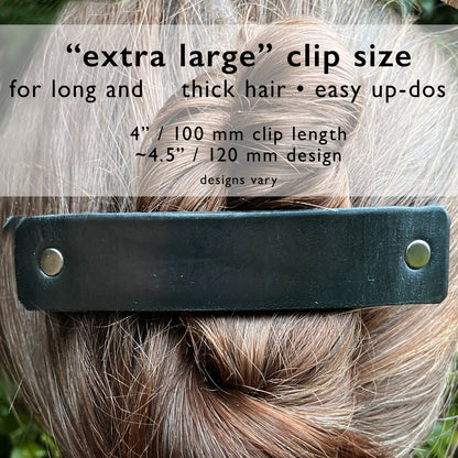 Silver feather hair barrette on black leather, stylish hair accessory by Orange Themis, perfect for elegant hair styling.