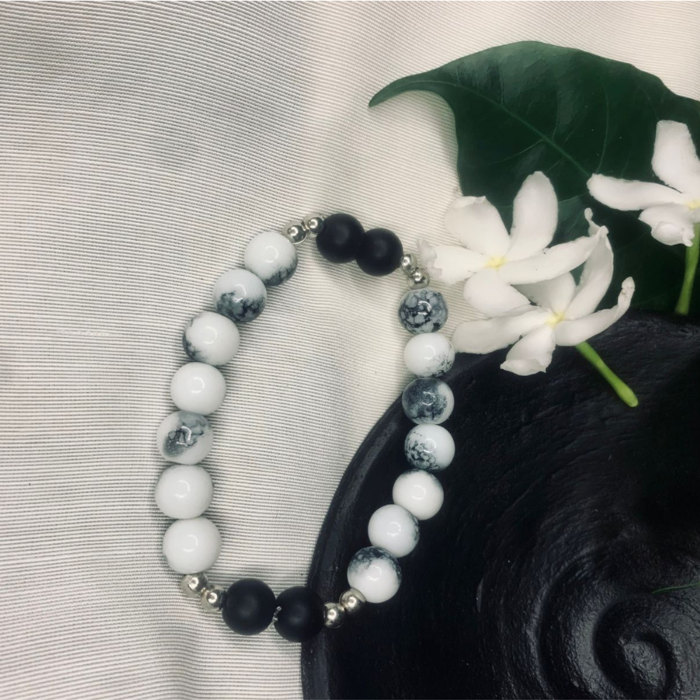 Stretch bracelet featuring Howlite and Black Onyx beads with silver spacers, by Tan Saffron.