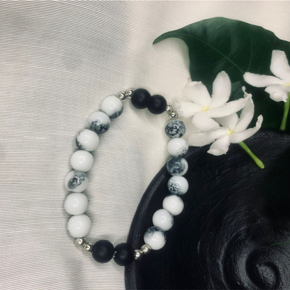 Stretch bracelet featuring Howlite and Black Onyx beads with silver spacers, by Tan Saffron.