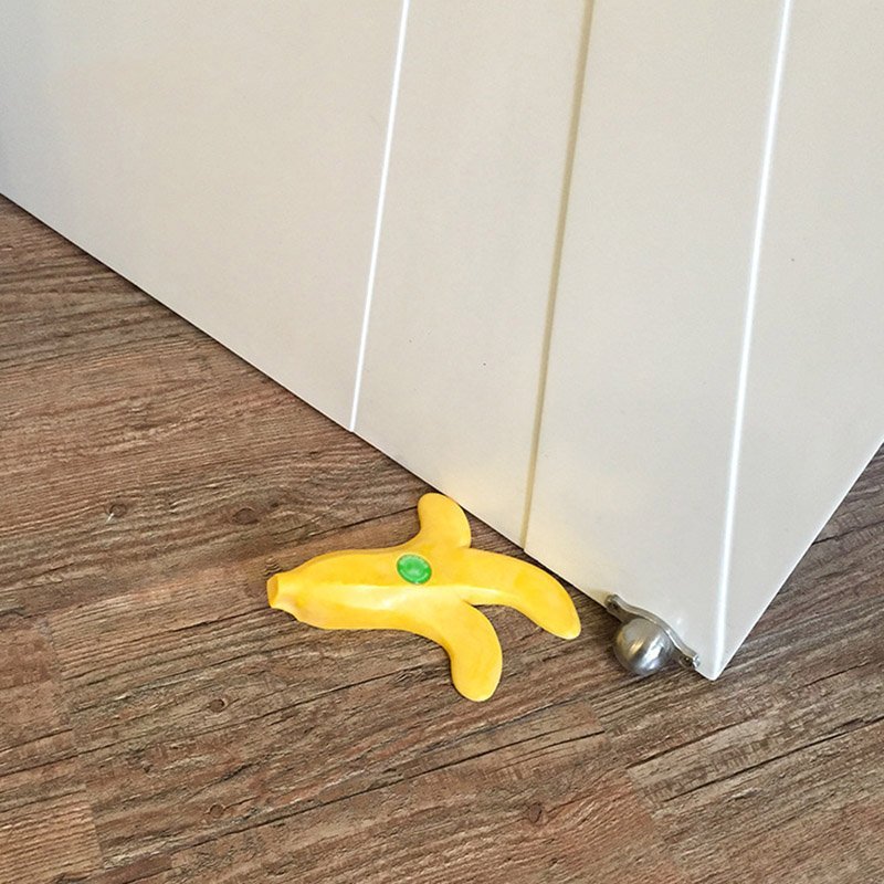 Fuchsia Molly banana-shaped doorstop in bright yellow with a textured surface for home and garden use.