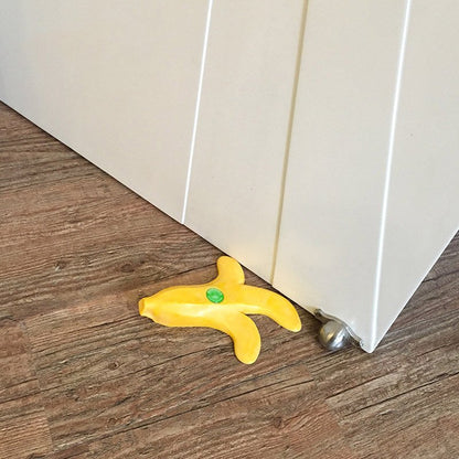 Fuchsia Molly banana-shaped doorstop in bright yellow with a textured surface for home and garden use.