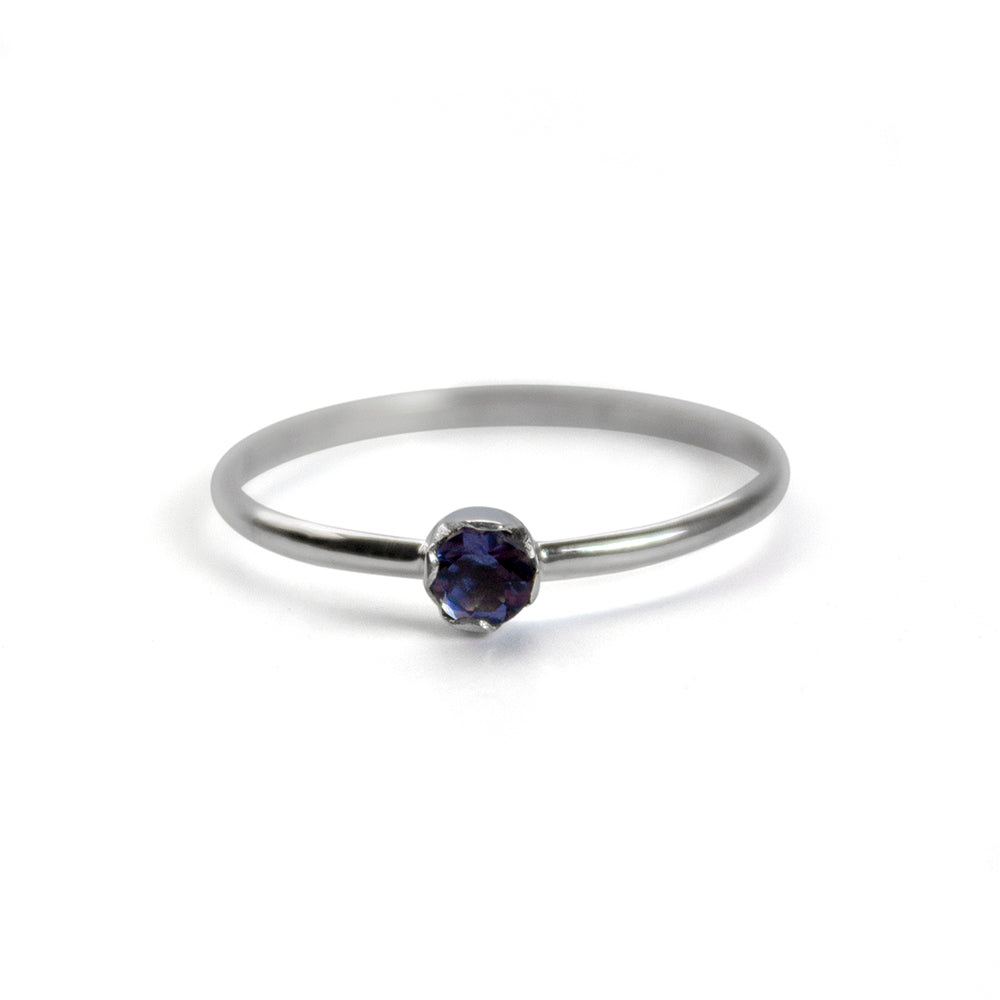 Sterling silver dainty solitaire ring featuring a polished Iolite gemstone, designed by Grey Clymene.