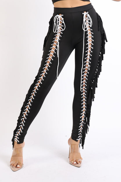 Black lace-up fringe tassel pants by Puce Juniper featuring detailed fringe and a stylish, fitted legging design.