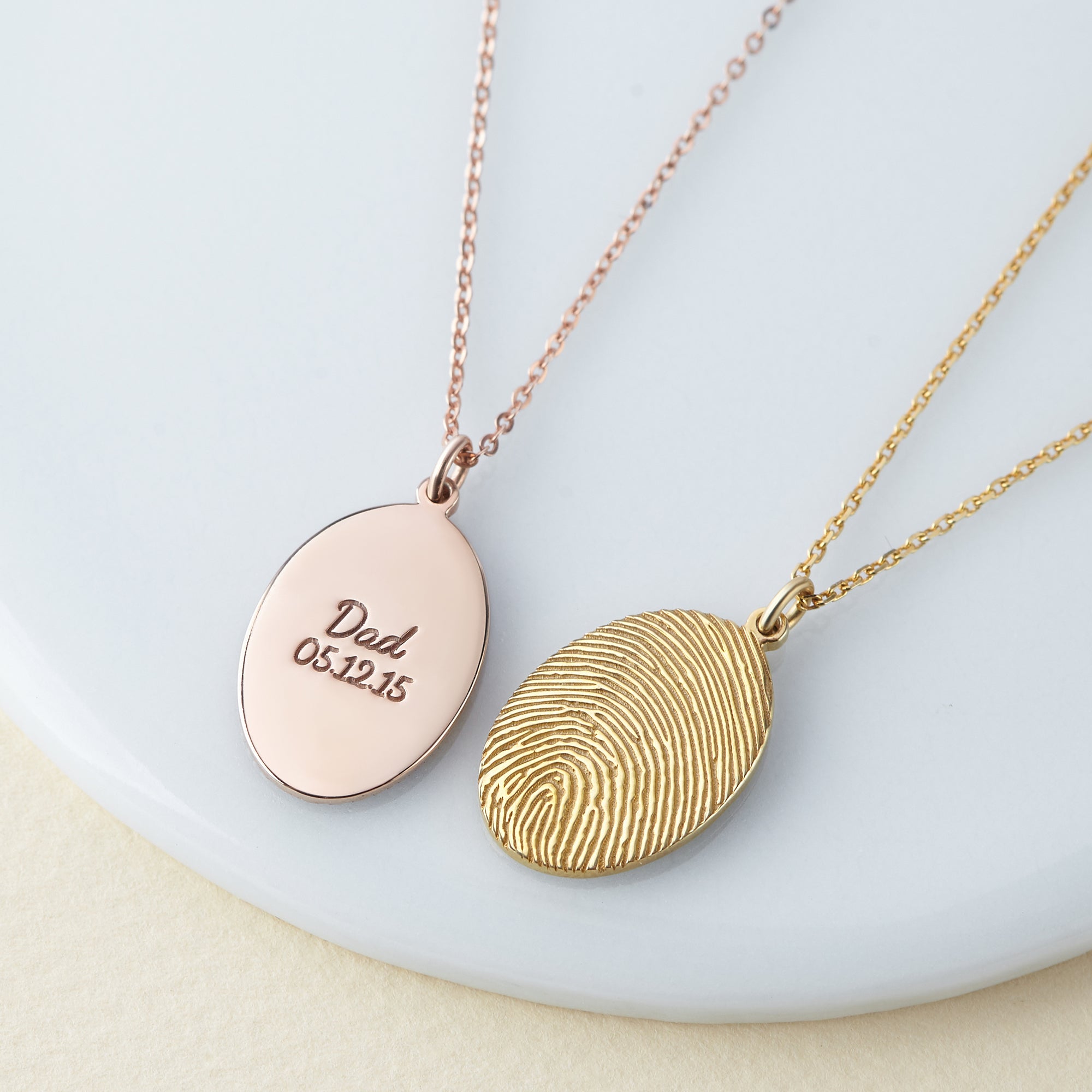 Green Millie fingerprint necklace featuring a personalized memorial thumbprint pendant on a delicate chain.