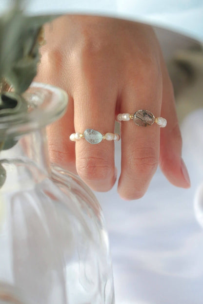 Elastic rings with natural crystals and freshwater pearls by Ultramarine Birch, showcasing elegant, colorful jewelry designs.