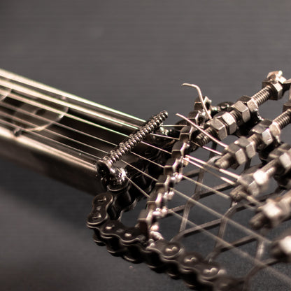 Metal electric guitar sculpture wall art by Turquoise Poppy, showcasing a detailed heavy metal design for home decor.