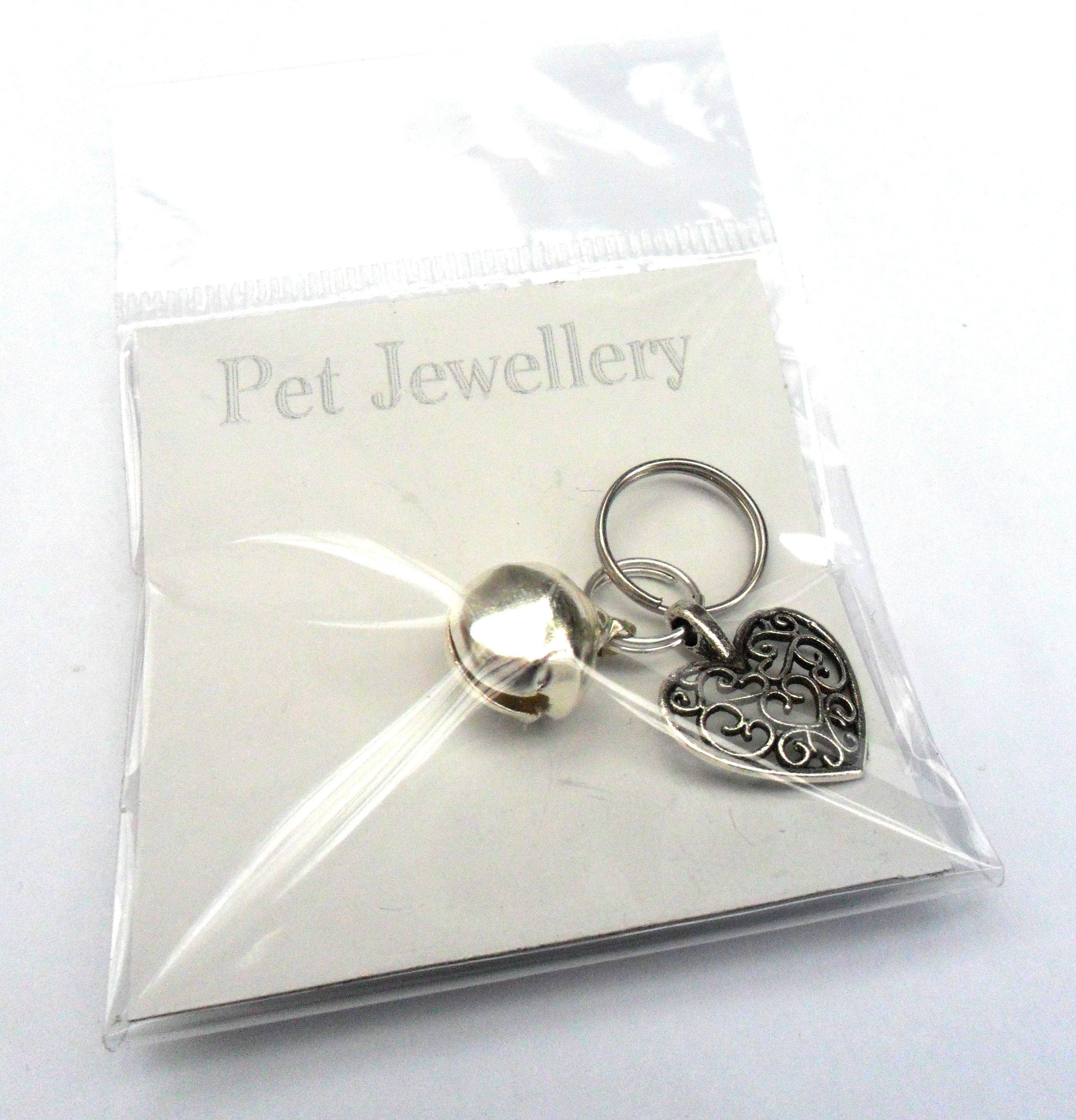 Salmon Oscar filigree heart pet charm attached to a collar, designed for leashes and petwear, featuring intricate metalwork.