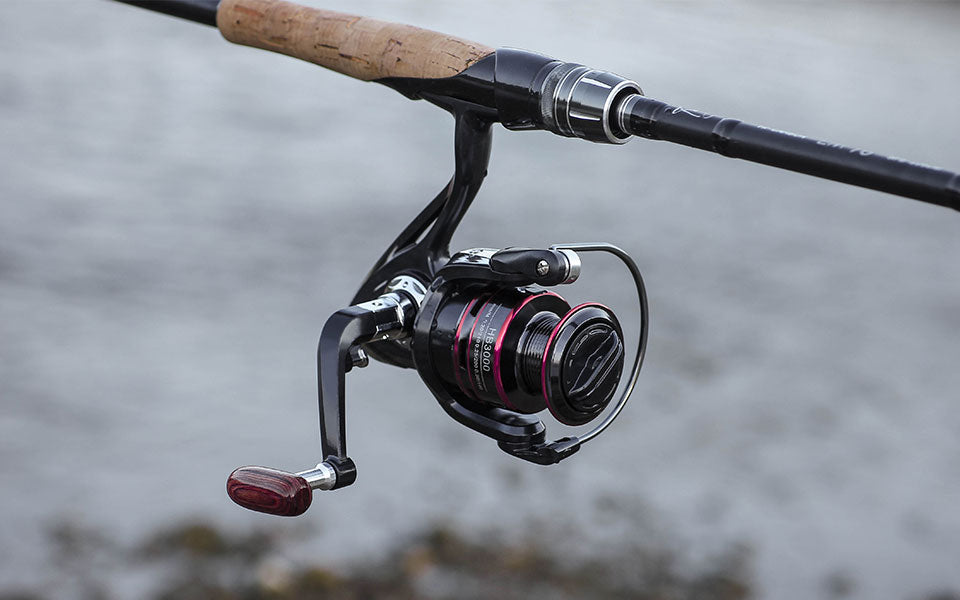 Teal Simba 8KG spinning reel handle with line spool for fishing, showing the metal handle and spool on a fishing reel.