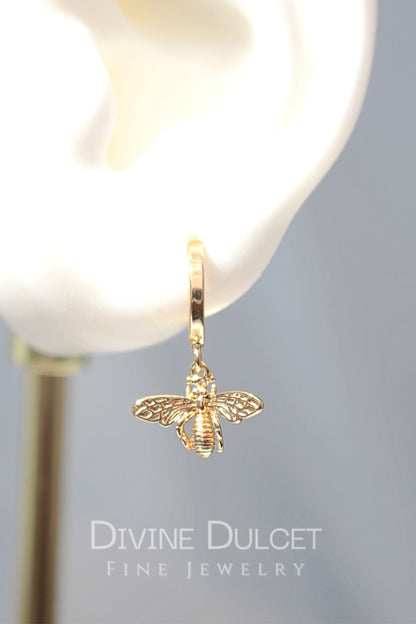 24 Karats gold bee hoop earrings by Ultramarine Birch featuring detailed bee charms on round hoop earrings.
