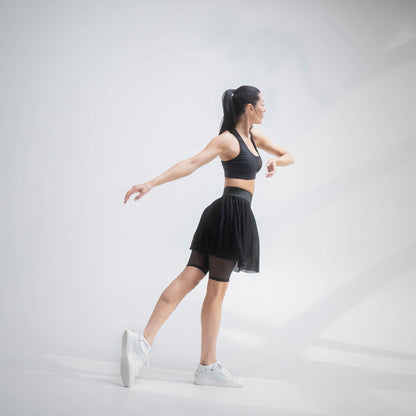 Indigo Thalassa MINI PLESSY MESH SKIRT showing a fitted, black mesh skirt with pleats and a high waist design.