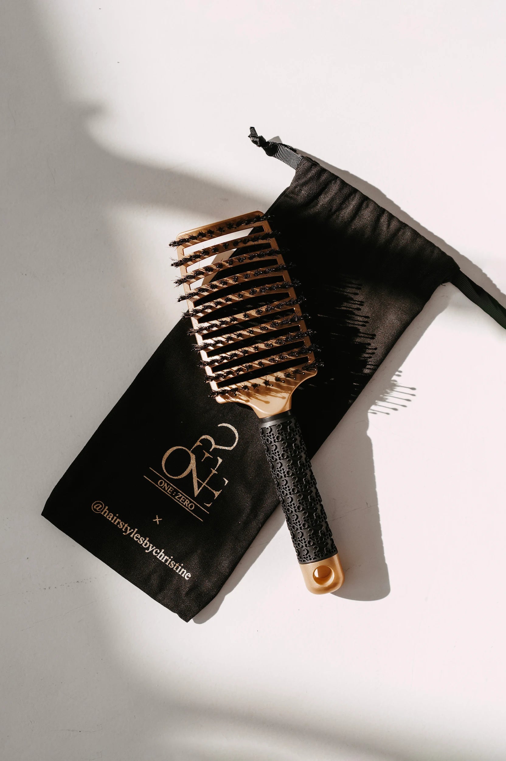Gold Burgundy Clover hair comb, a stylish haircare accessory with finely detailed teeth for detangling and styling.