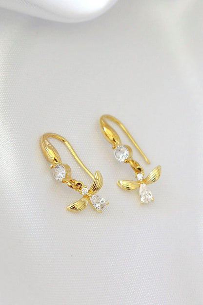 Ultramarine Birch 18K gold bee hook earrings featuring detailed bee-shaped design on shiny gold hooks.