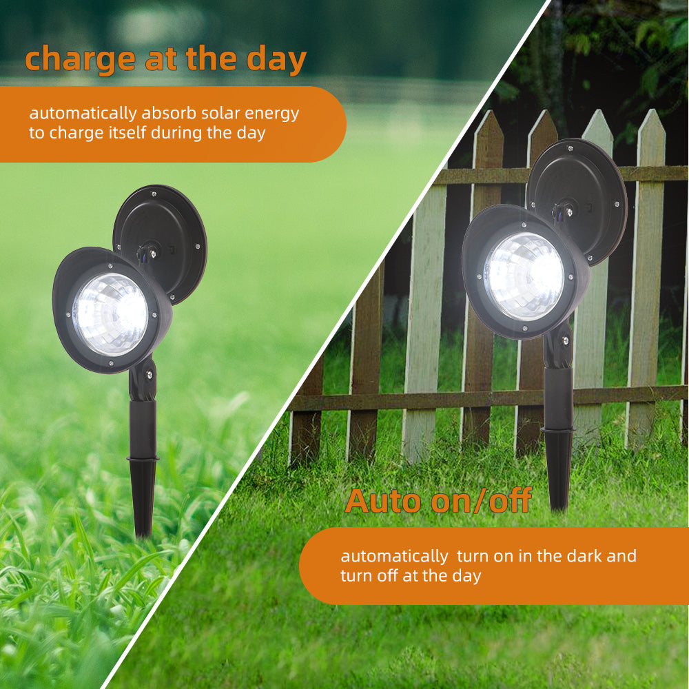 Two Lilac Milo solar landscape LED spotlights illuminating a garden area outdoors.