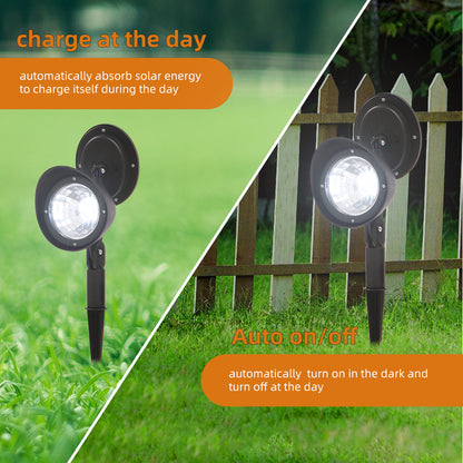 Two Lilac Milo solar landscape LED spotlights illuminating a garden area outdoors.