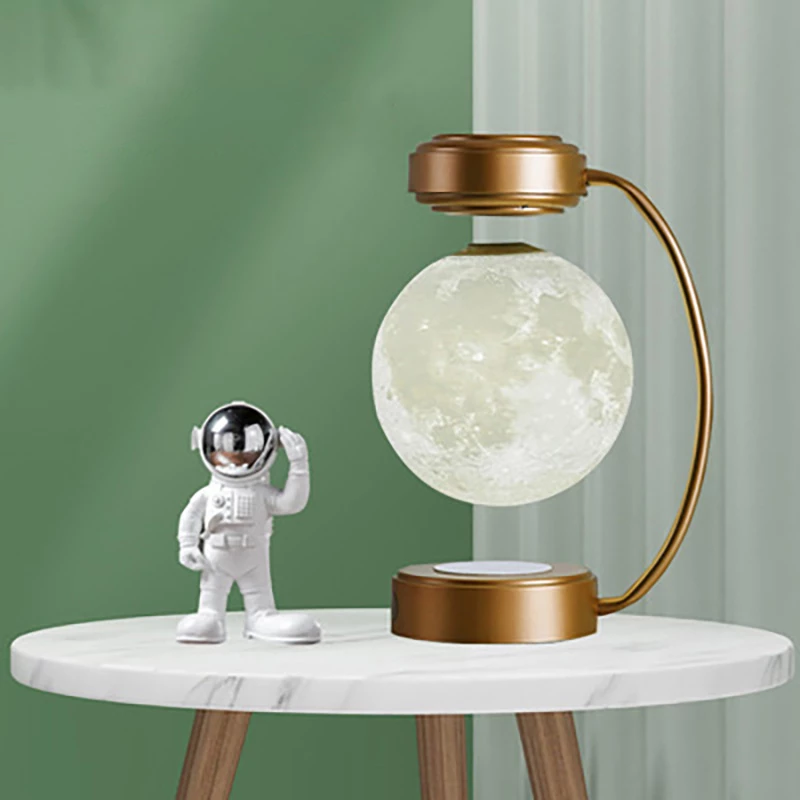Teal Simba Creativity Magnetic Levitation Moon Lamp with LED lights, rotating and dangling in a sleek tech accessory design.