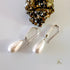Maroon Smudge Dew Drop teardrop shell pearl earrings featuring elegant, shiny pearl drops on silver hooks.
