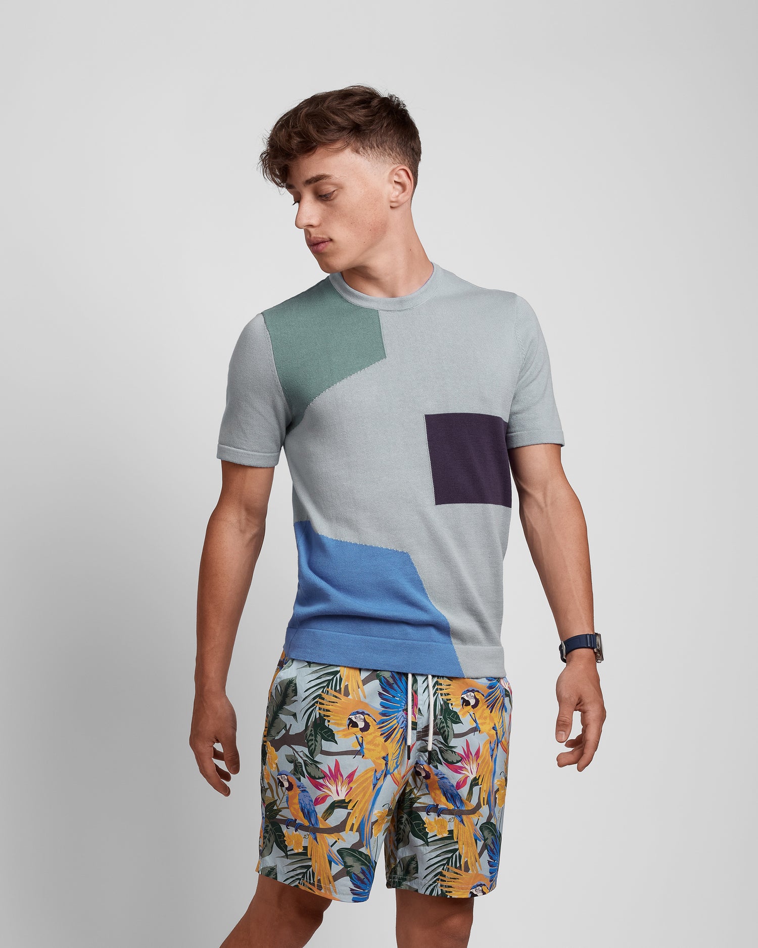 Violet Castor multicolored crew neck short sleeve knit tee with an art deco pattern, featuring vibrant geometric designs.