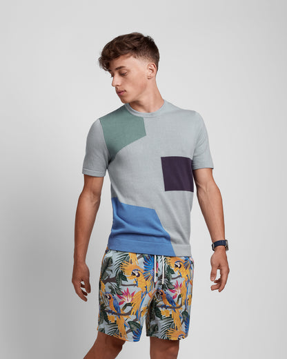 Violet Castor multicolored crew neck short sleeve knit tee with an art deco pattern, featuring vibrant geometric designs.