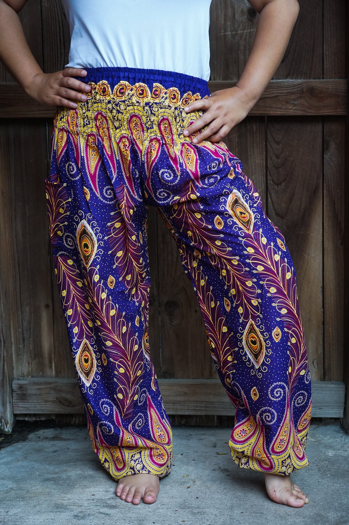 Tan Smokey boho hippie peacock print gypsy pants in vibrant purple with flowing, relaxed fit and bohemian style.