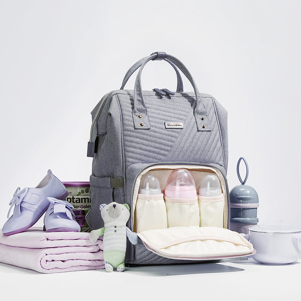 Modern quilted diaper bag backpack by Maroon Chronos for kids and babies, featuring multiple compartments and padded straps.
