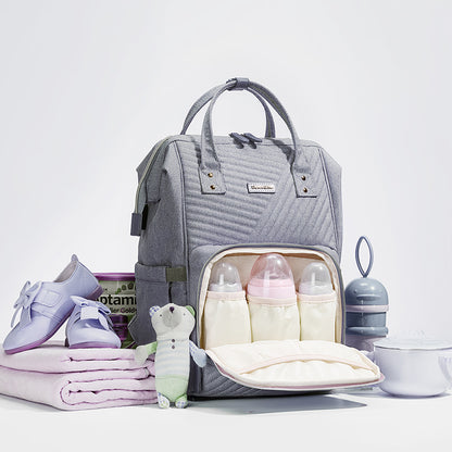 Modern quilted diaper bag backpack by Maroon Chronos for kids and babies, featuring multiple compartments and padded straps.