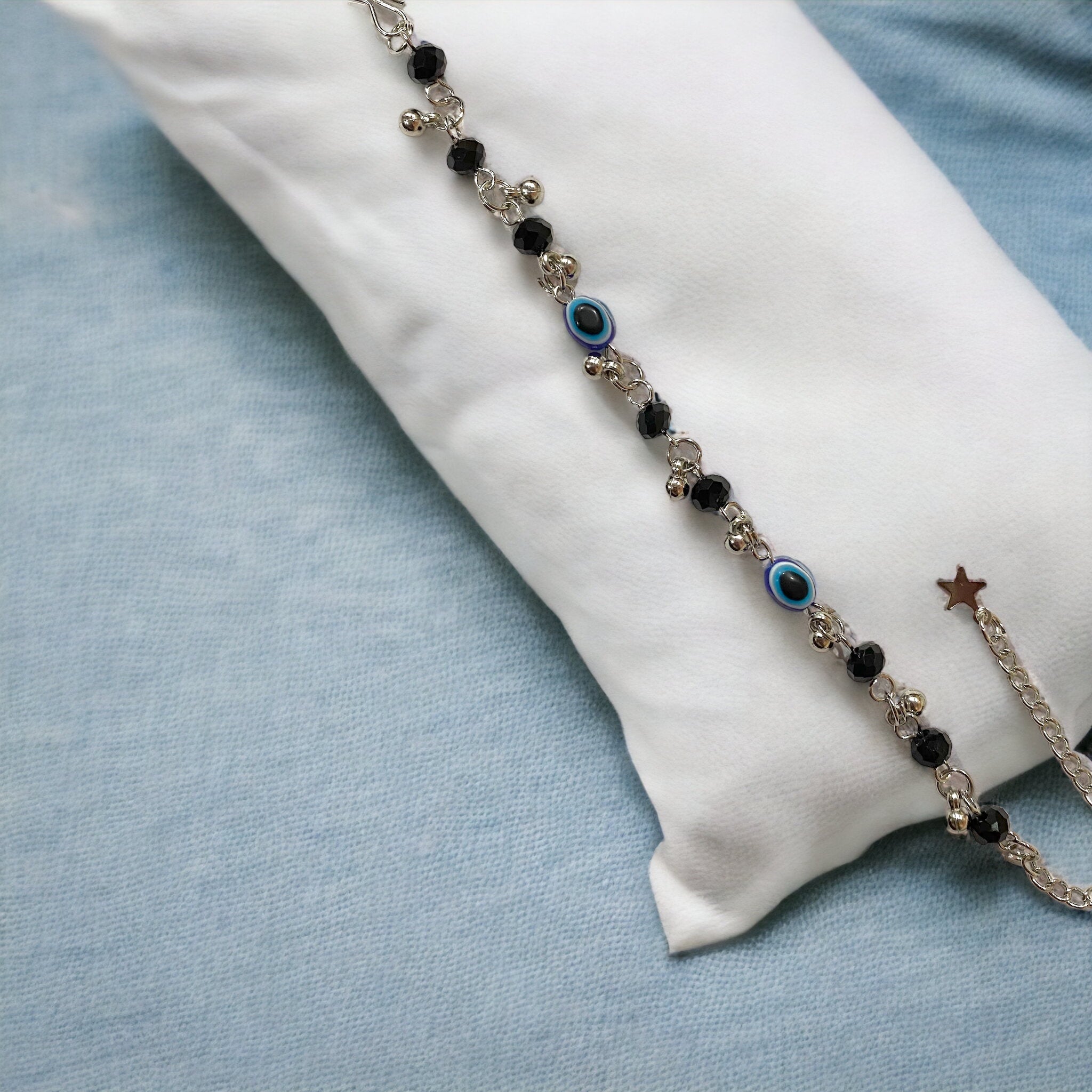 Gray Poseidon Fortune’s Shield Evil Eye bracelet with blue and silver beads, designed for jewelry and watch enthusiasts.