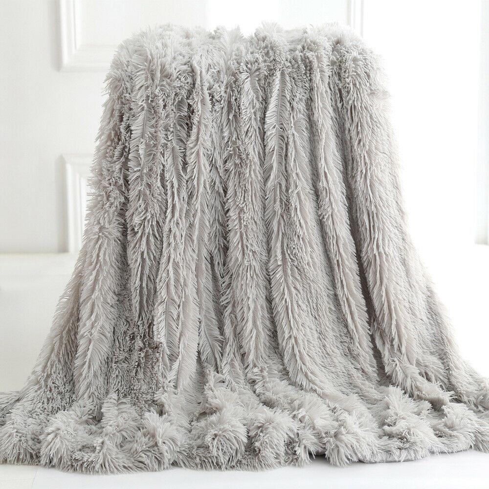 Yellow Pandora ultra soft faux fur throw blanket draped over a cozy armchair in a stylish home setting.