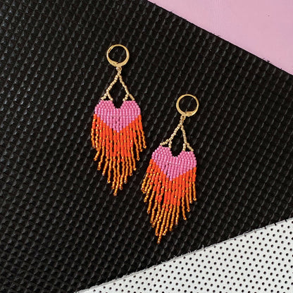 Yellow Athena LOVE earrings with pink and orange ombre fringe, featuring a stylish and vibrant earring design.