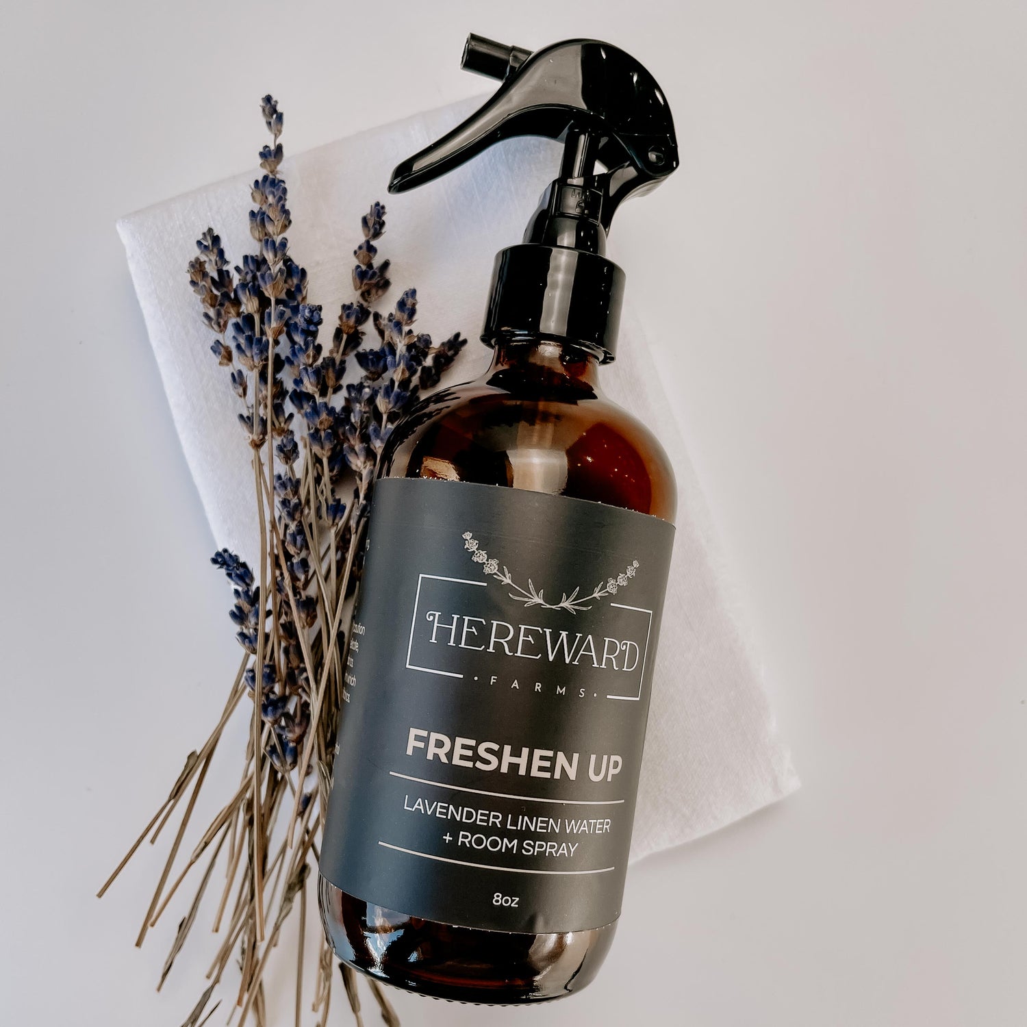 Periwinkle Poplar Freshen Up Linen and Room Spray in a bathroom setting, showcasing its elegant bottle and fresh scent.