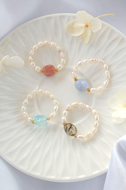 Ultramarine Birch elastic rings featuring natural crystals and freshwater pearls, showcasing delicate designs and vibrant materials.