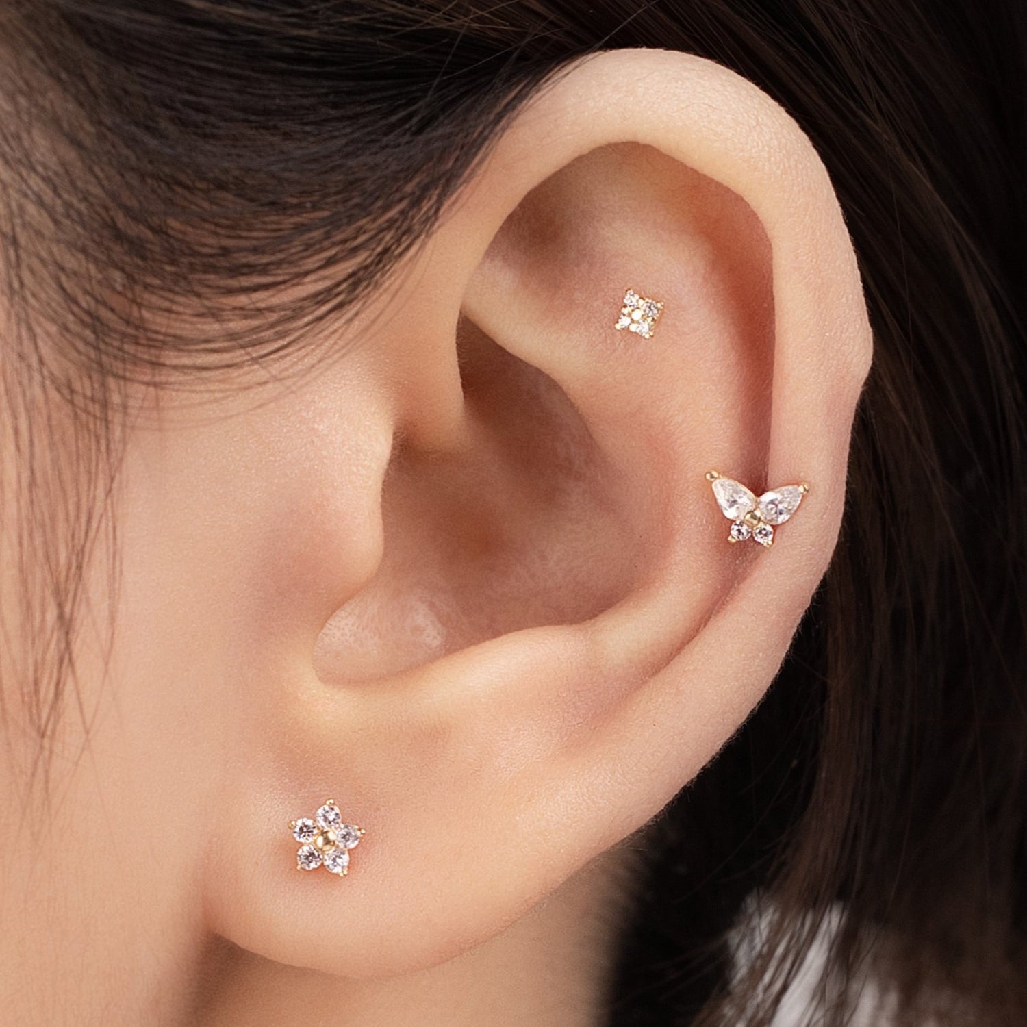 Blue Chrysippus 14K solid gold moth piercing earrings, detailed design with a shiny gold finish, displayed on a neutral background.