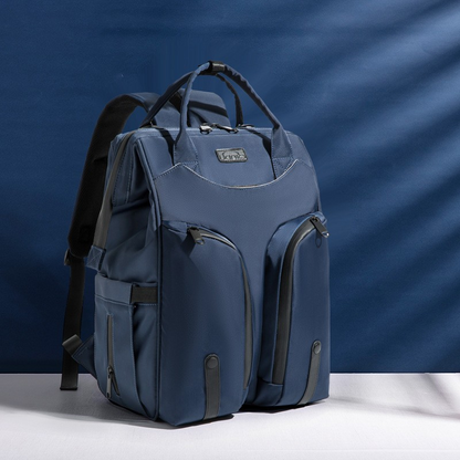 Carmine Juneberry SmartMom Travel+ diaper backpack with multiple compartments and adjustable straps, ideal for parents on the go.
