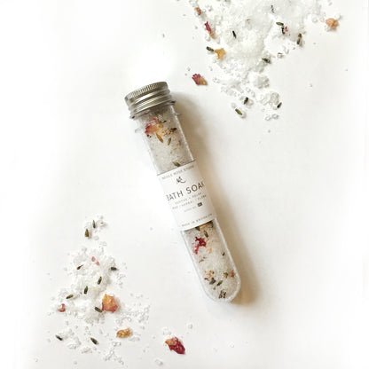 Indigo Poseidon Soothe + Relax Bath Soak Shooter with calming herbal ingredients in a clear glass jar.