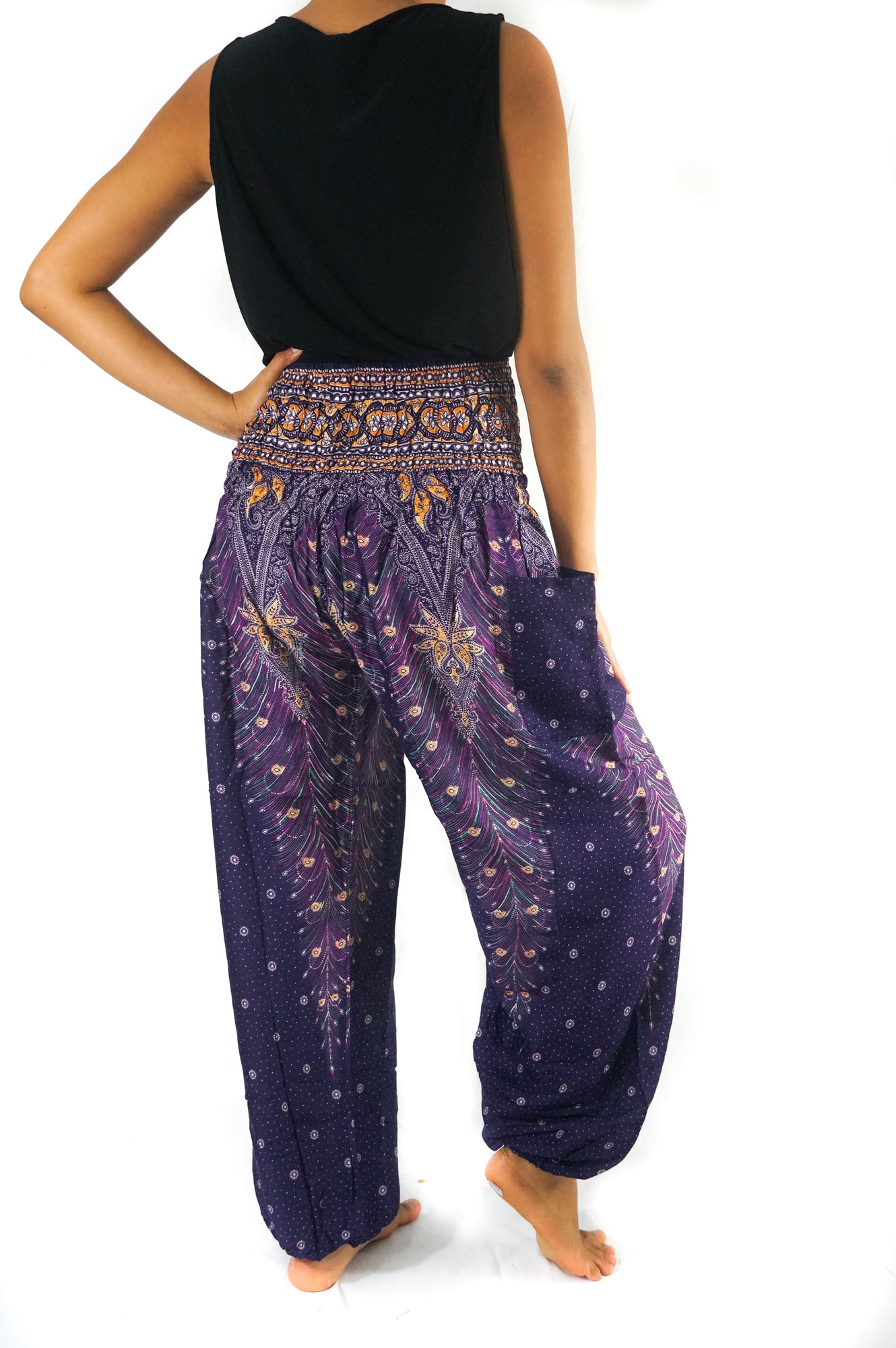 Purple boho harem pants for women by Tan Smokey featuring a peacock pattern and loose, comfortable hippie style.