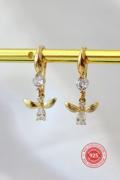 18 karat gold bee hook earrings by Ultramarine Birch featuring delicate bee-shaped dangle design with intricate detailing.