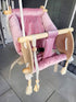 Pink Ochre Ares cradle-swing for kids and babies, showcasing a cozy, cushioned seat with safety harness and swinging mechanism.