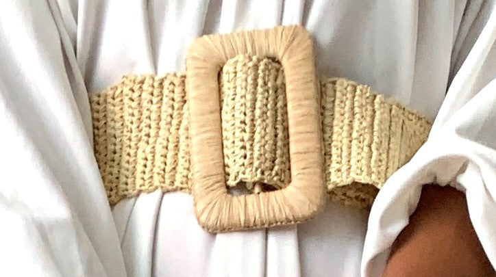 Olive Artemis Lemloreli wide straw belt styled around a woman’s waist, showcasing natural woven texture and summer fashion accessory.