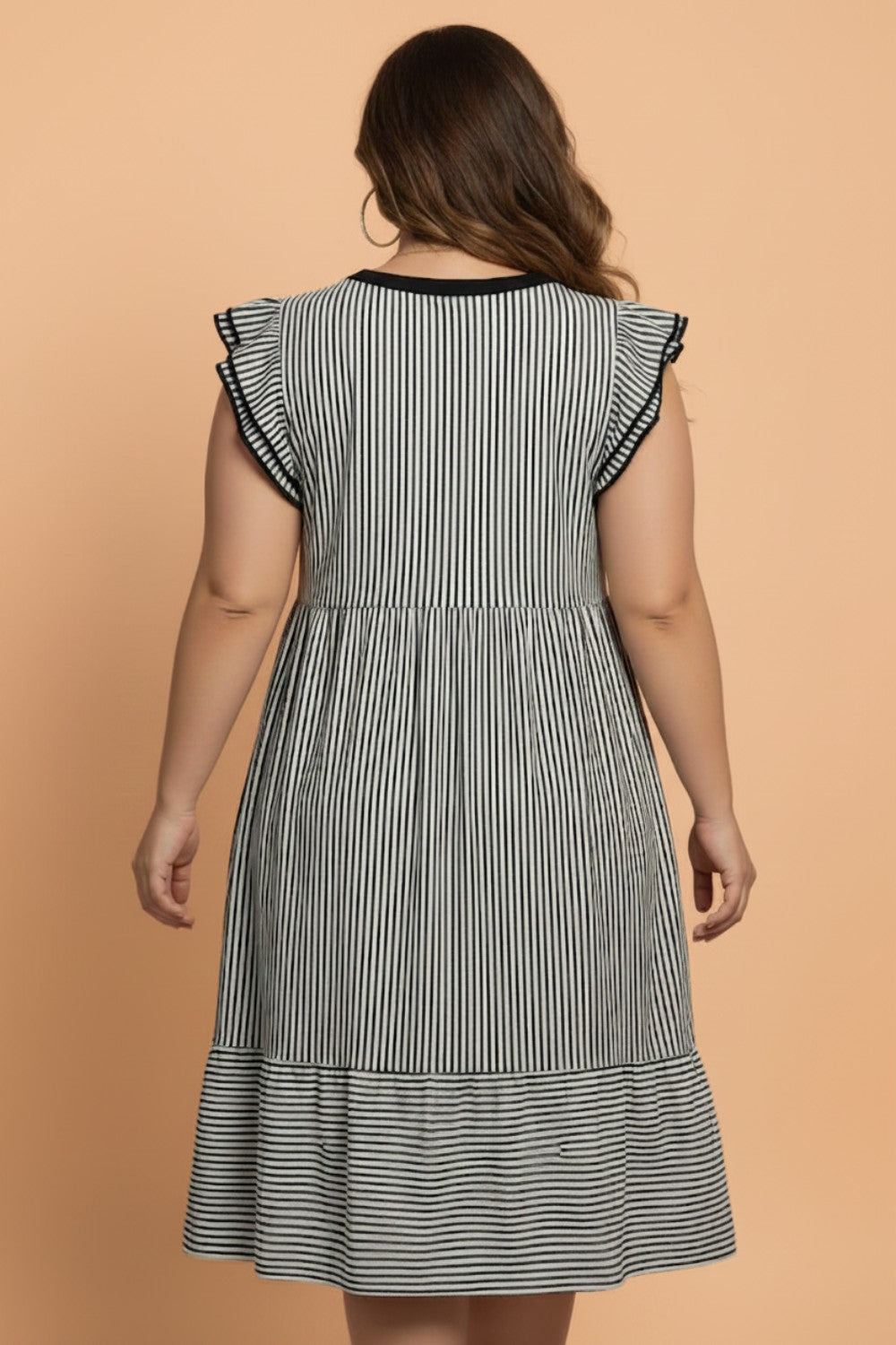 Plus size stripe flutter sleeve V-neck maxi dress by Byzantium Bay, showcasing the flowing fabric and colorful striped pattern.