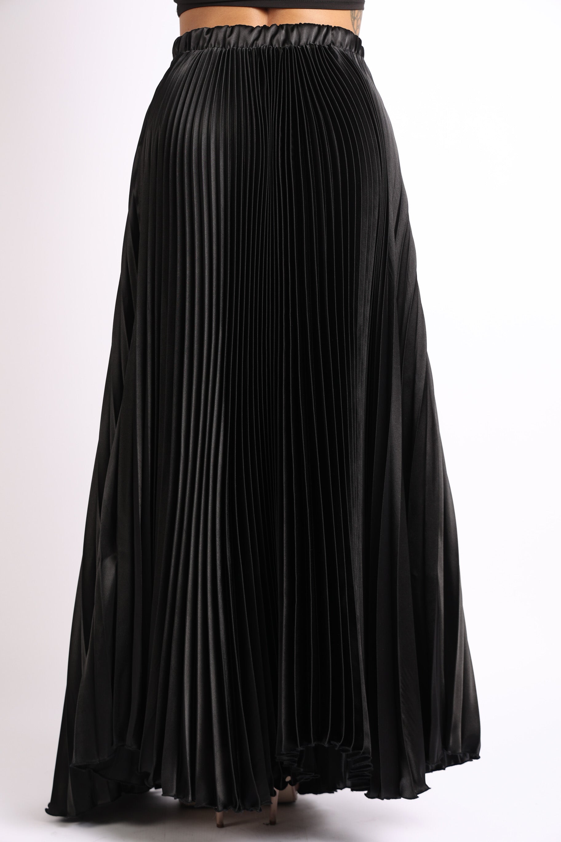 Black satin elastic high waist A-line pleated maxi skirt by Puce Juniper with flowing, elegant pleats and a flattering waist fit.