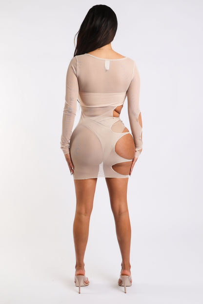 Nude long sleeve mesh dress with cut-out details by Puce Juniper, featuring sheer fabric and form-fitting design.