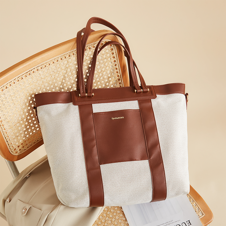 Maroon Chronos canvas tote diaper bag with multiple pockets and handles, designed for parenthood and accessories.