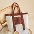 Maroon Chronos canvas tote diaper bag with multiple pockets and handles, designed for parenthood and accessories.
