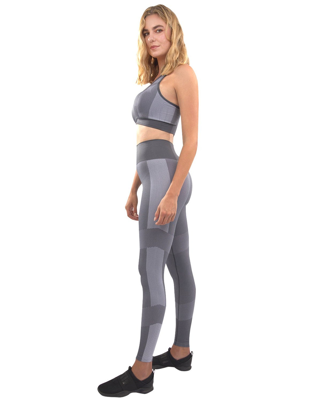 Grey Lazurite Arleta seamless leggings and sports bra set for women, shown on a model in a fitness pose.