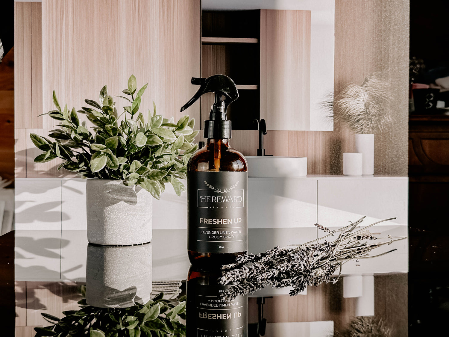 Periwinkle Poplar Freshen Up Linen and Room Spray in bathroom setting, showcasing the elegant spray bottle and fresh scent.