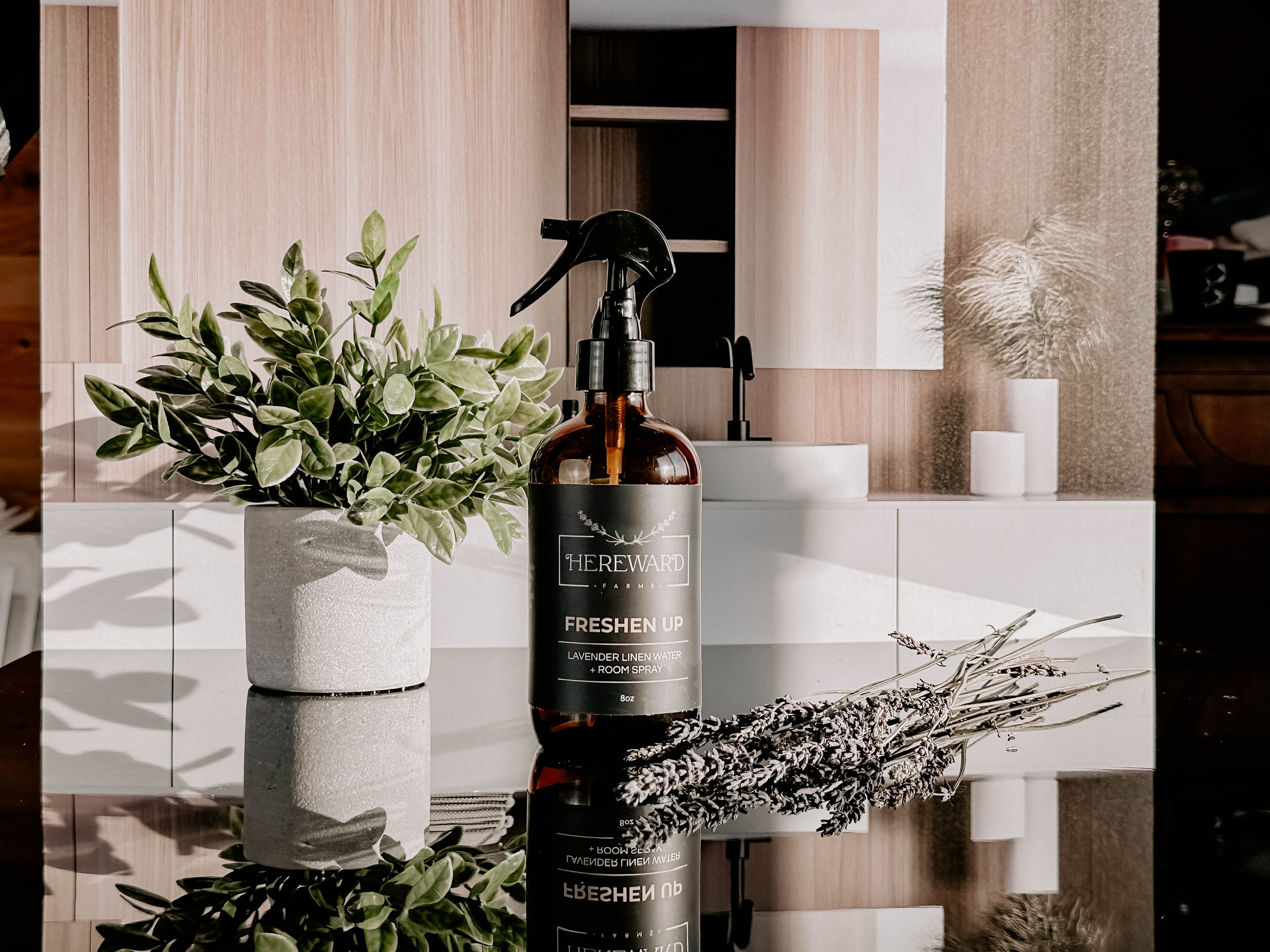 Periwinkle Poplar Freshen Up Linen and Room Spray in bathroom setting, showcasing the elegant spray bottle and fresh scent.