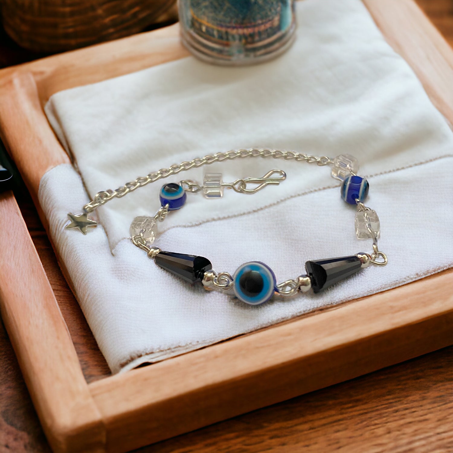 Gray Poseidon Fortune’s Shield Evil Eye bracelet featuring a protective blue eye charm on a silver chain.