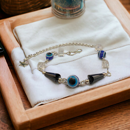 Gray Poseidon Fortune’s Shield Evil Eye bracelet featuring a protective blue eye charm on a silver chain.