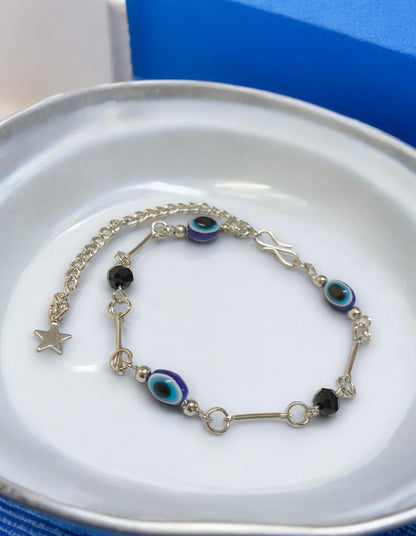 Gray Poseidon Fortune’s Shield Evil Eye bracelet featuring protective blue and silver jewelry design on a delicate chain.